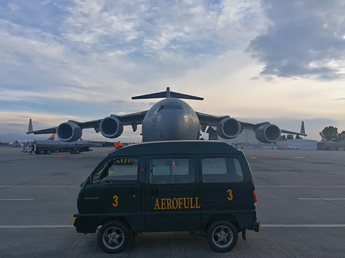 Aerofull operations van beside a military transport aircraft